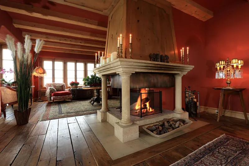 The pillared open fireplace in the drawing room of Chalet Kalem