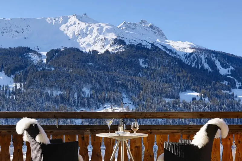 Breakfast table on the balcony of Chalet Kolin, facing snowy peaks