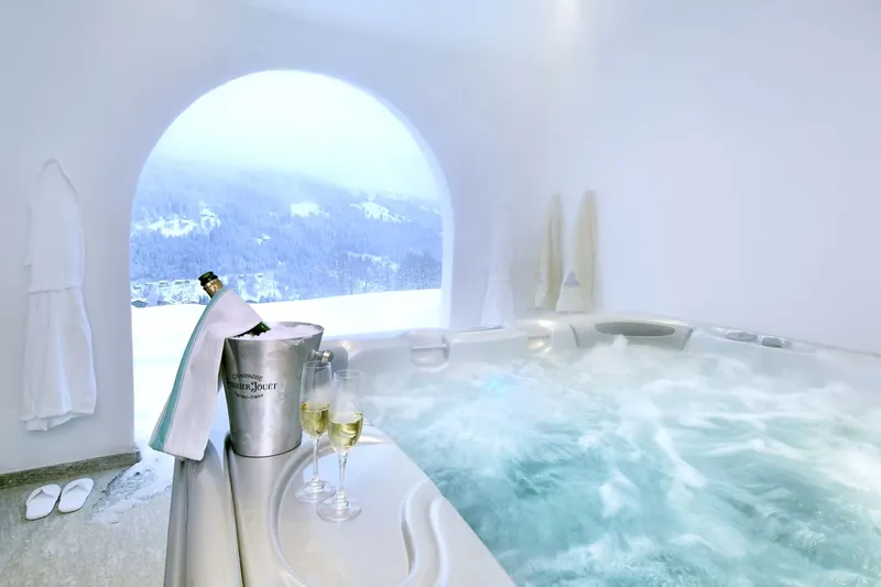 Outdoor hot tub at Chalet Kolin with a snowy mountain view
