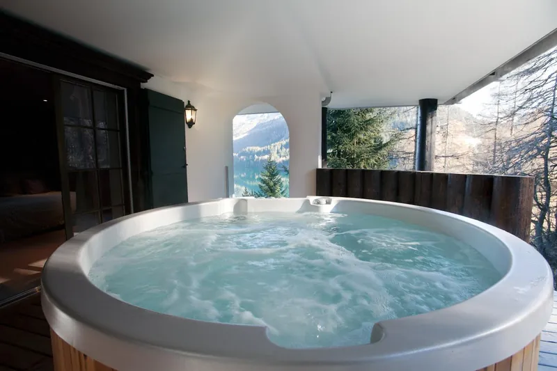 Covered outdoor Jacuzzi at Chalet Magan with a mountain view